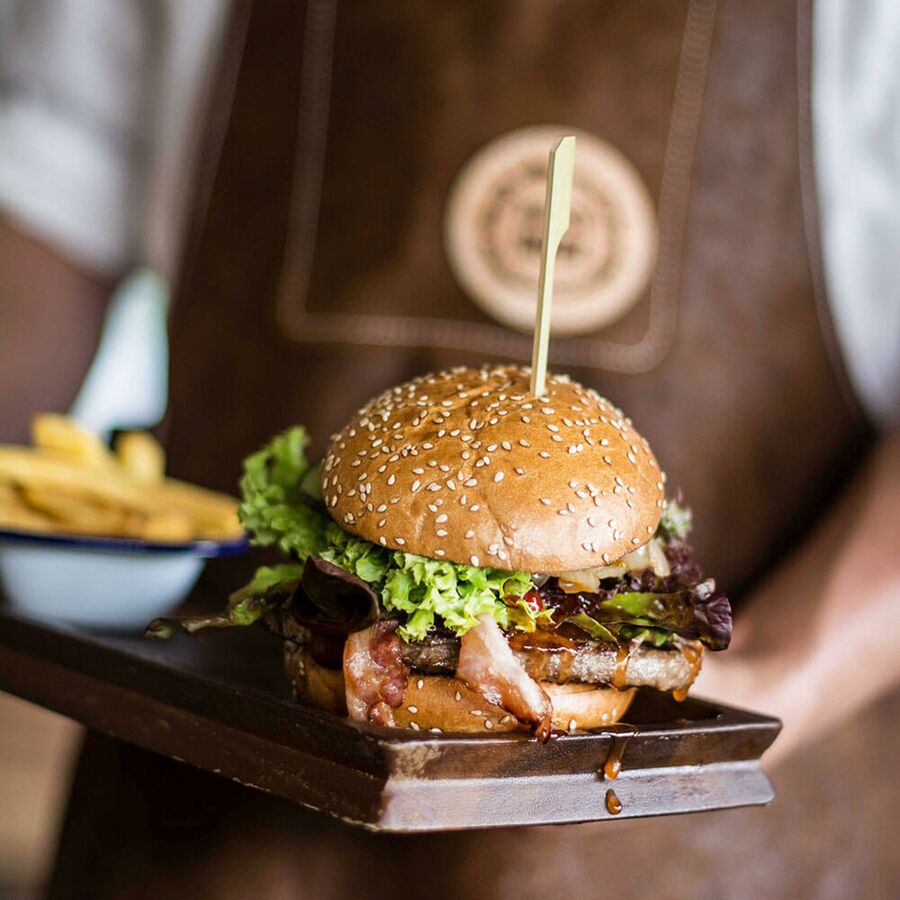 Juicy burger served with fries at Hotel Das Katschberg